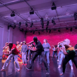 A large group of people dance on stage at Citadel + Compagnie, during the Kevin A. Ormsby and KasheDance Showcase, 2023.