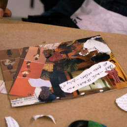 Close-up of two hands working on a collage at Juliane Foranda’s workshop at the Ottawa Art Gallery, 2023.